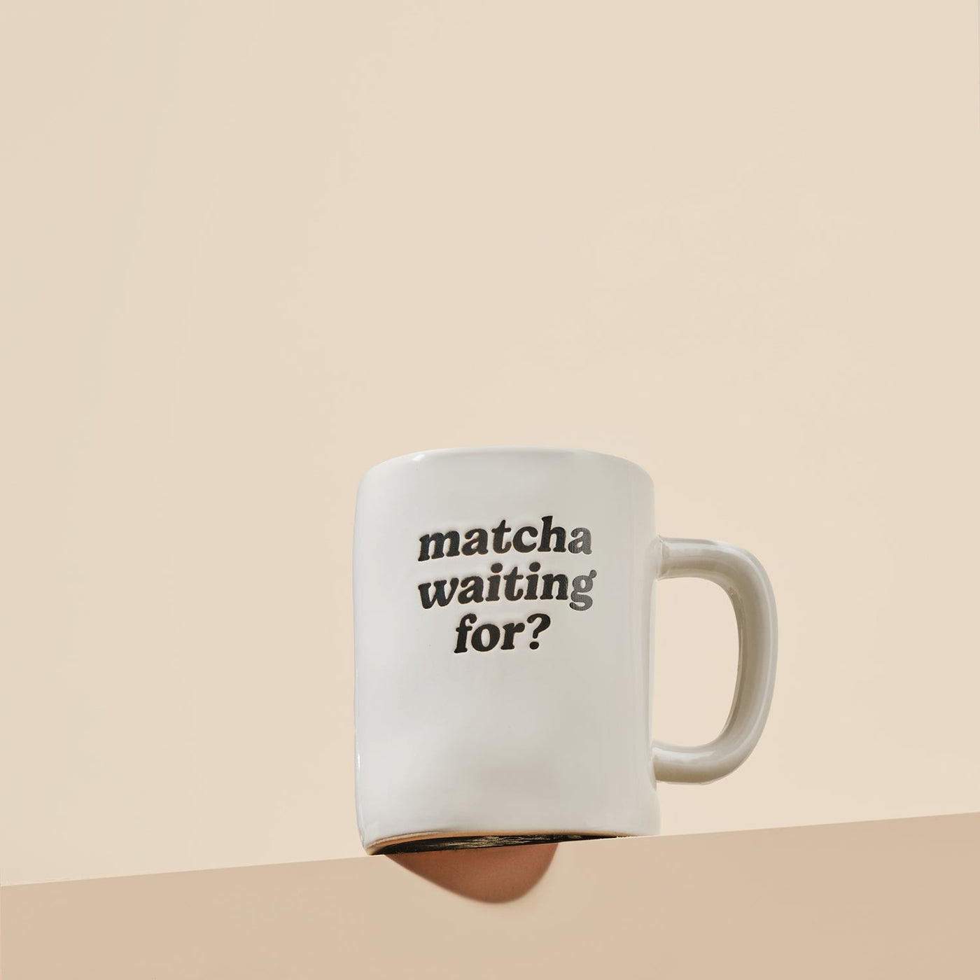 White mug with 'matcha waiting for?' text on a beige background